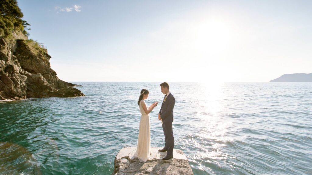 Couple reading their vows to eachother in italy during their elopement on the sea 