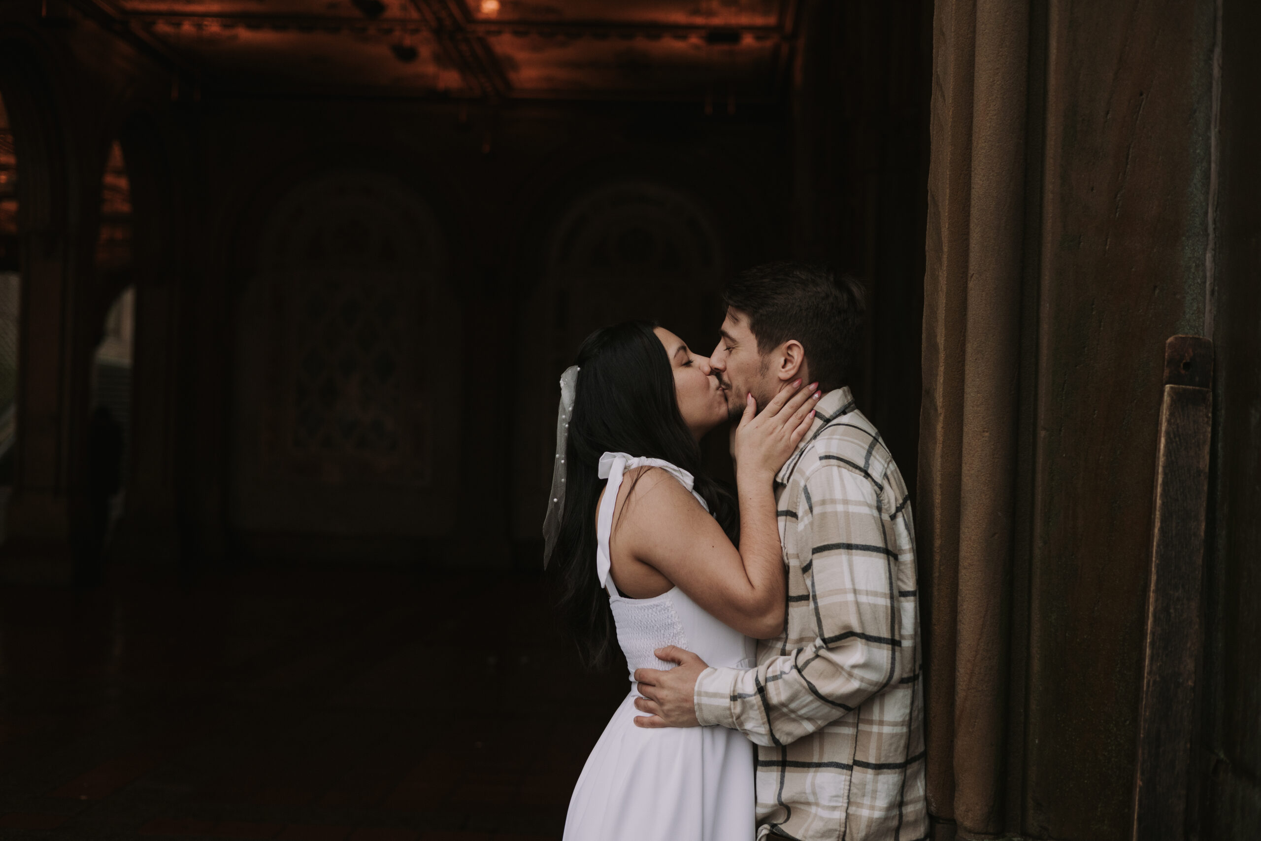 New York City couple kissing at Bethesda Terrace