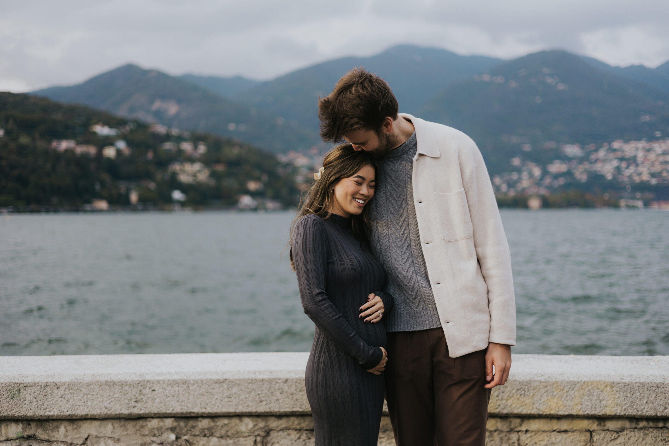 Husband hugging wife while enjoying lake como